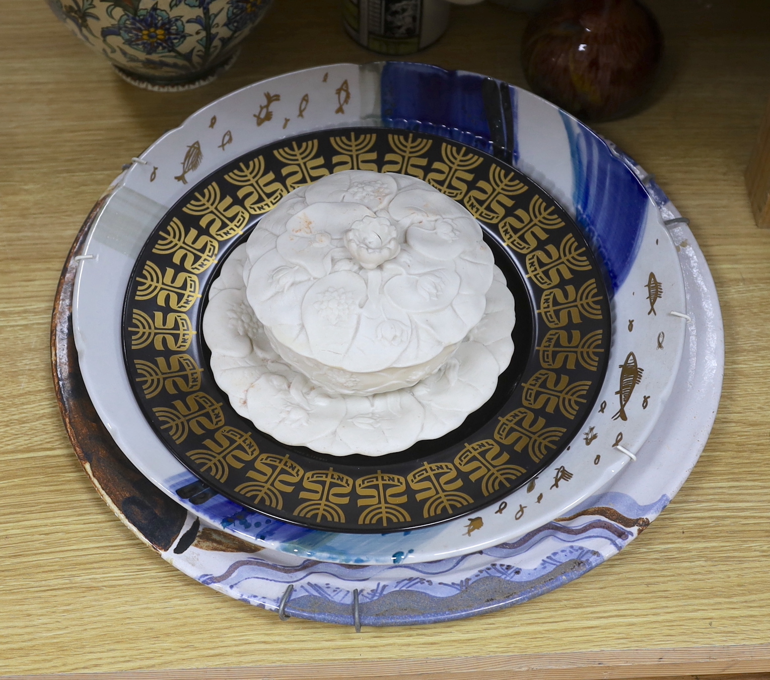 Assorted contemporary ornamental ceramics including chargers, celadon style teapot and vase decorated with stylised flowers, the largest 38cm in diameter